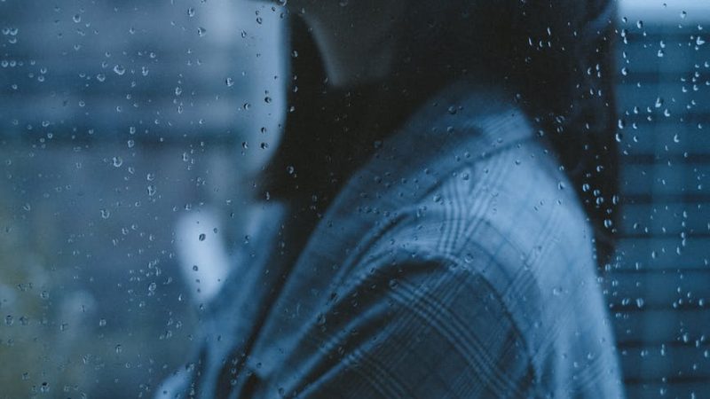 unhappy thoughtful teen girl arms crossed in rainy day